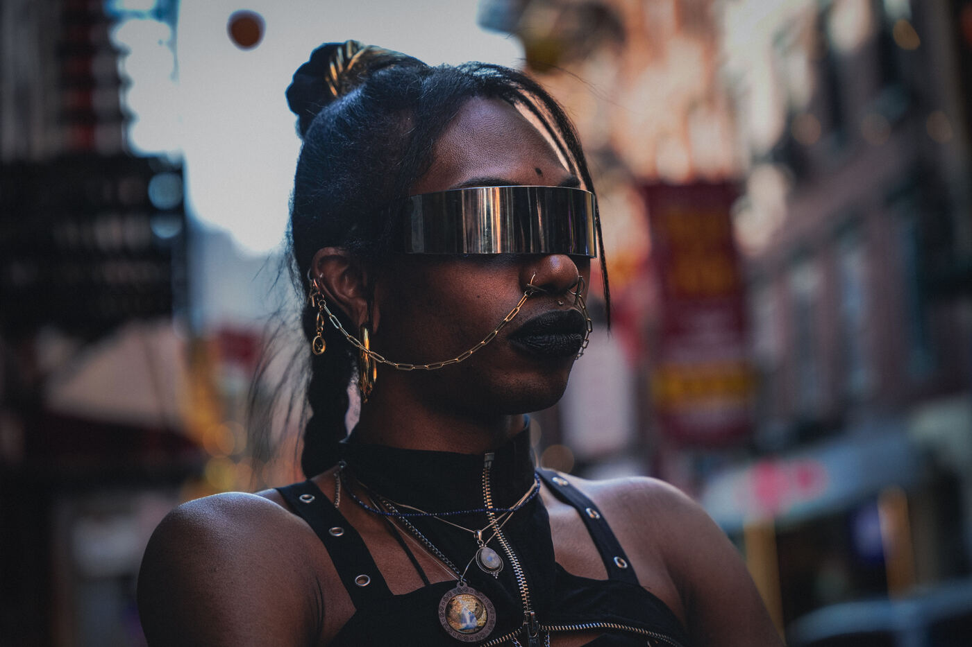 Editorial portrait with chrome visor and gold chains