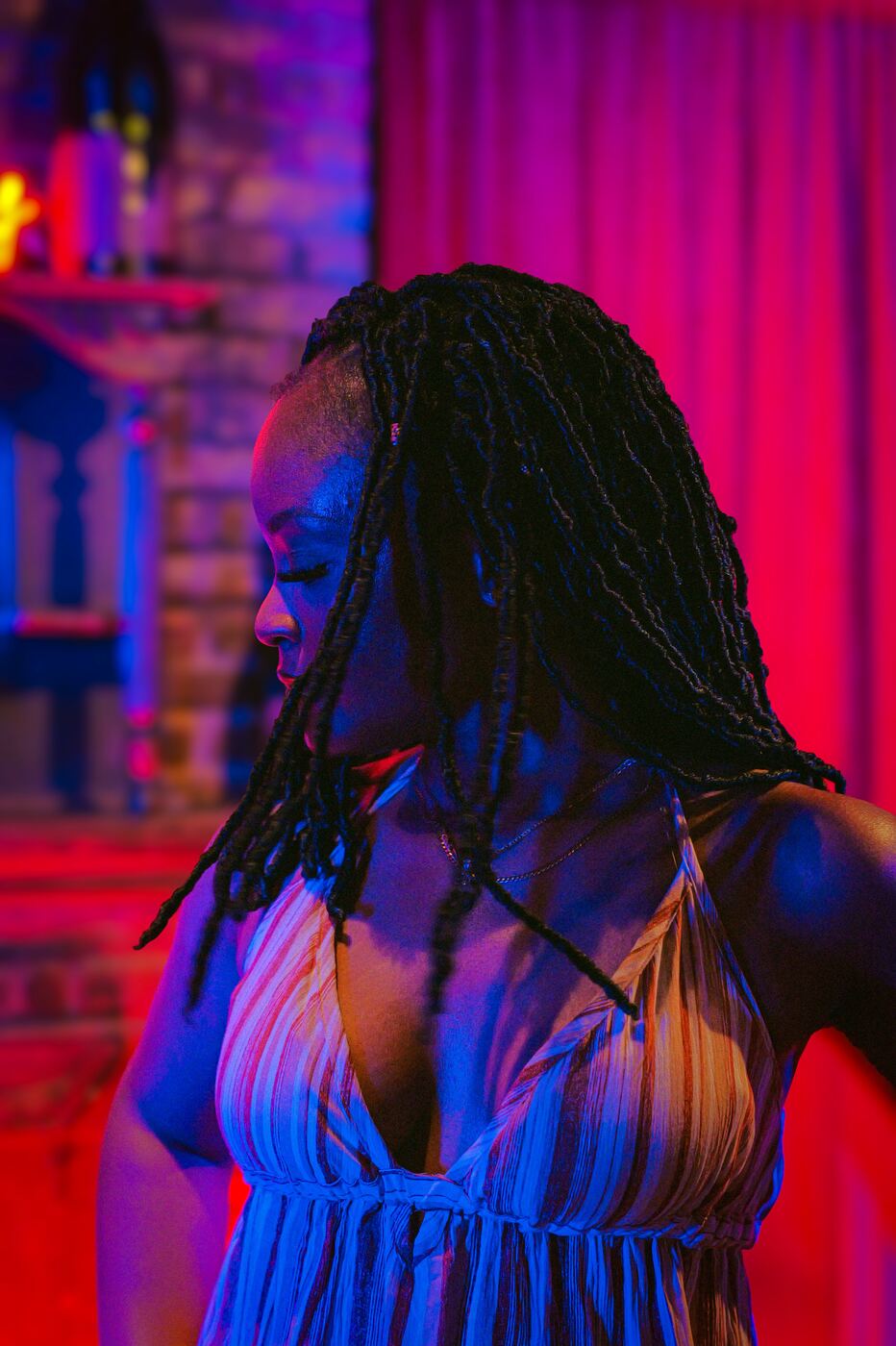 Woman dancing under red and blue neon light